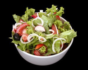 Fresh salad with onion, tomato and basil on black