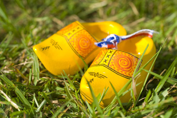 Dutch yellow wooden shoes outdoor in the grass