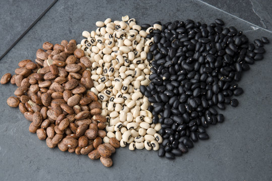 Black, Pinto And Black-eyed Beans On A Slate Background.