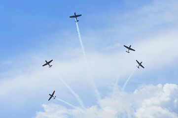 Group of old timer planes performing acrobatics in the air