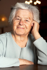 Senior adorable woman sitting at the table