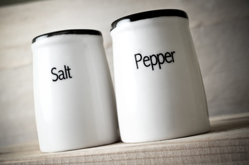 Toned photo of saltshaker and pepper pot, taken from below