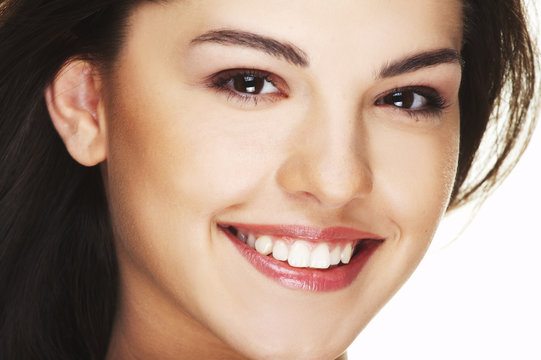 A happy young woman with big smile on white background