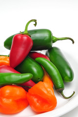 Jalaneno, Serrano and Habanero chilis in a white bowl