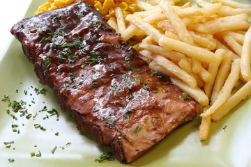 BBQ marinated spareribs and fries, with sweet corn.