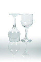Two isolated empty goblets stanting on glassy background