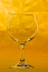 empty wine glass on gold background