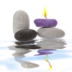 Candle and River Stones on background
