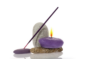 Candle and River Stones on background