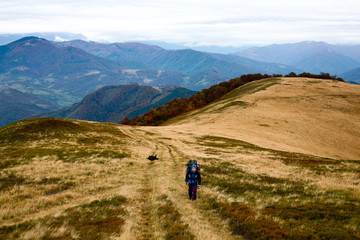 Fototapeta premium Autumn theme: an image of tourist in mountains