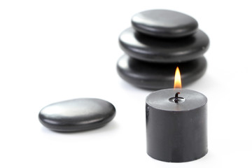 Obraz na płótnie Canvas black pebbles with candle isolated on white