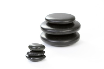 black pebbles isolated on white - health and beauty