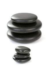 black pebbles isolated on white - health and beauty