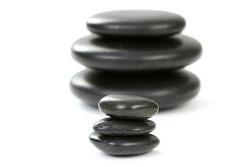 black pebbles isolated on white - health and beauty