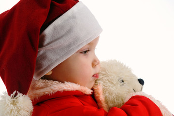 Profile of an surprised baby with toy in christmas