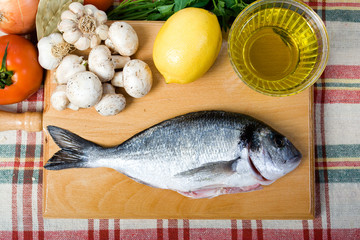 sea bream and food ingredients on a table