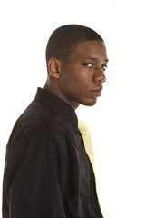 Obraz premium A young black man wearing black suit and yellow tie on white