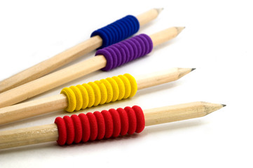Four pencils with colourful grips, isolated on white