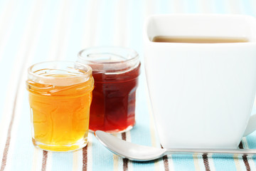 cup of delicious tea with sweet confiture