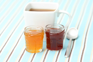cup of delicious tea with sweet confiture