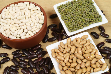 Four sorts of beans in ceramic bowls. Cuisine composition.