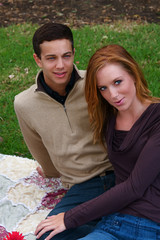 Young couple in an autumn forest picnic area