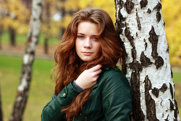 Beautiful young woman in autumnal park