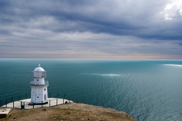 Fototapeta na wymiar lighthouse on marine cape