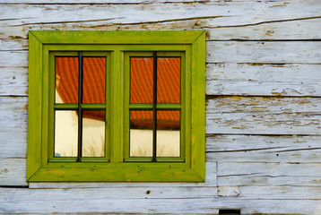 Naklejka na ściany i meble A shot of a window in a wooden wall