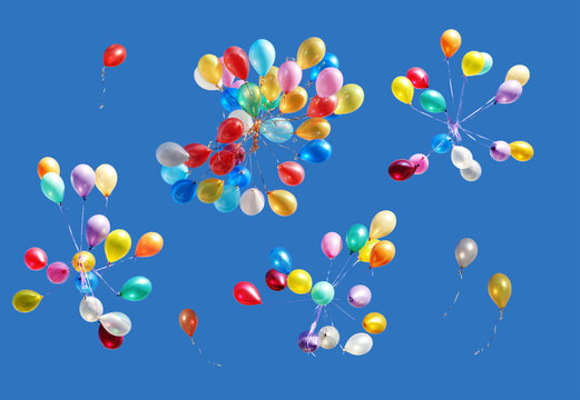 Many color balloons isolated on blue