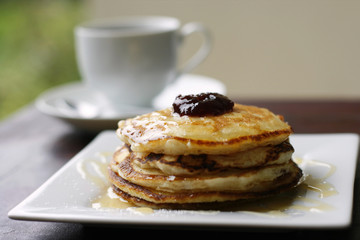 Pancakes with jam and a cup of coffee