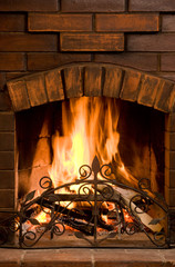 Close-up of bright and hot fire burning in chimney