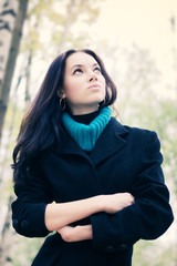 Young woman outdoors portrait. Soft yellow and blue tint.