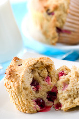 Closeup of cranberry muffins and glass of milk.