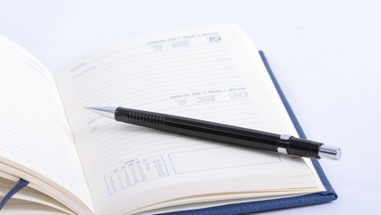an open notebook with pencil