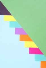 arranged colourful paper with stripes as background