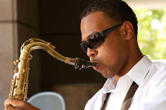 An young and trendy African-American sax musician