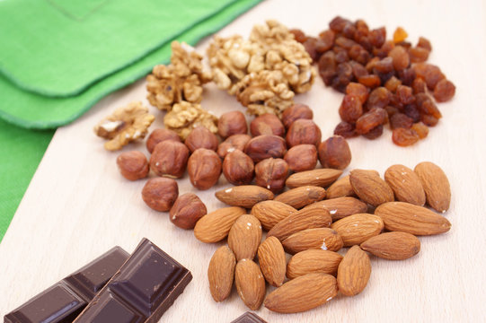 almonds and walnuts on board isolated on white background