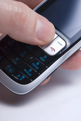 Mobile cellphone being activated by thumb.