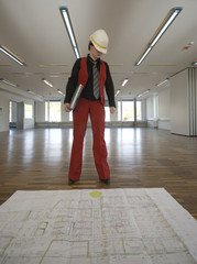 Fototapeta premium Planerin bei Baukontrolle mit Bauplan