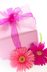 Gift box wrapped in pink paper with ribbon and bow