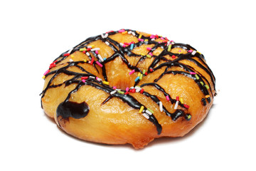 Donut with chocolate icing and colorful sprinkles over white.