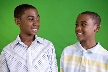 Two young African American males smiling friendly smiles.