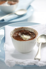 Chocolate pudding, topped with melting fresh cream.
