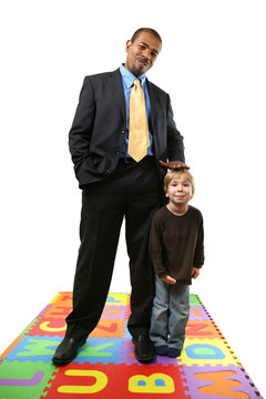 Tall African American Businessman With Small Caucasian Boy.