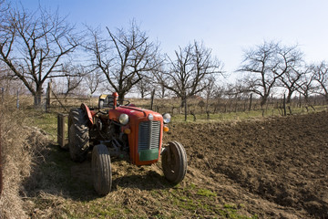 old red tractor in a field