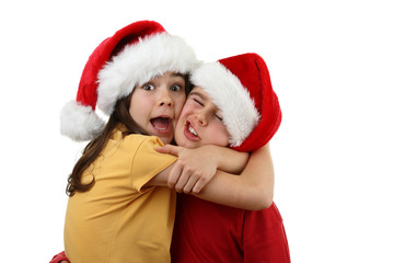 Kids wearing Santa Claus hats isolated on white background