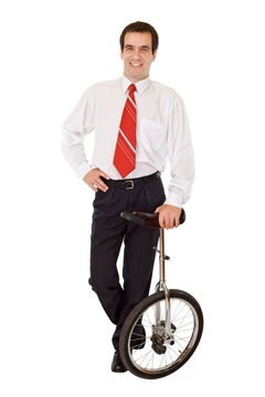 Balance in business concept - businessman with monocycle