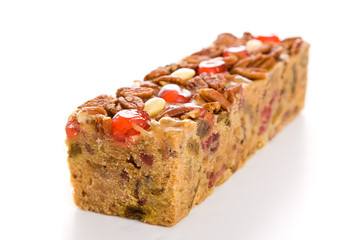 Moist, delicious Christmas fruitcake isolated on white