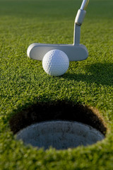A short put in the game of golf with a ball and a putter